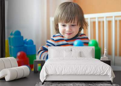 toddler boy plays plastic blocks Wall mural