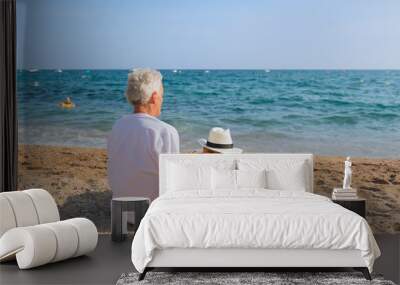 Senior man with dog at the beach Wall mural