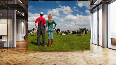 Typical Dutch landscape with farmer couple and cows Wall mural