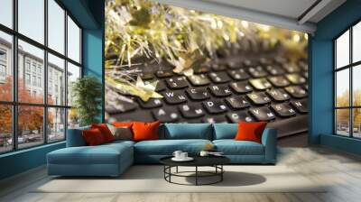 Keyboard with english and russian letters. On top of the keyboard is shiny tinsel. Wall mural