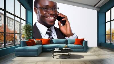 Businessman in a suit smiling while talking on the phone in a bright office setting during the day Wall mural