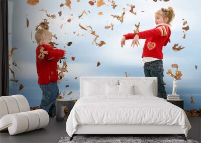 brother and sister throwing leaves Wall mural