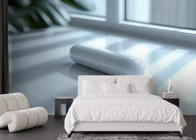 A sleek white object resting on a surface near a window. Wall mural