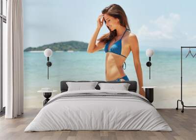 beautiful shapely woman on the beach. Holiday time Wall mural