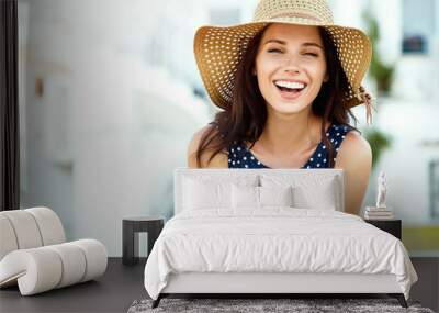 Portrait of a beautiful woman in a straw hat. Laughing girl. Summer time Wall mural