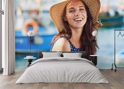 Portrait of a beautiful woman in a straw hat. Laughing girl. Summer time Wall mural