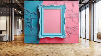 A blue ornate picture frame on a pink and blue textured wall. The frame is empty, ready for your design. Wall mural