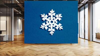 Christmas snowflake decoration on blue background. Minimalistic Christmas concept Wall mural