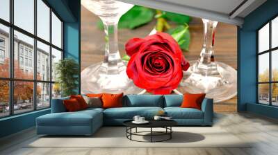 Valentines Day composition with two wine glasses and red rose on wooden background. Romantic celebration concept.  Wall mural