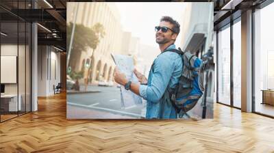 experience the natural, cultural and man-made wonders of the world. shot of a young man looking at a Wall mural