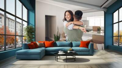 Property, happy couple moving into their new home and boxes in living room. Happiness or smiling, mortgage or homeowners and people hugging celebrating with their new house or apartment together Wall mural