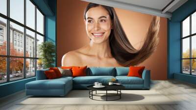 Hair, beauty and skincare with a model woman in studio on a brown background for natural or keratin treatment. Face, haircare and salon with an attractive young female posing to promote a product Wall mural