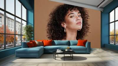 Black woman, beauty and skincare face portrait for natural afro, facial or hair care cosmetics. Healthy, beautiful and assertive model with curly hair shine and texture in brown studio background. Wall mural