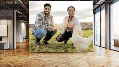 Farm, livestock and portrait of a couple with a chicken on an agriculture, sustainable and green field. Poultry, eco friendly and agro man and woman with a animal to monitor growth in the countryside Wall mural