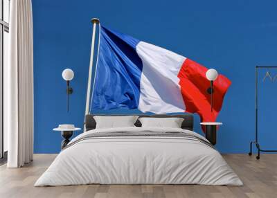 Flag of France waving over a blue sky Wall mural