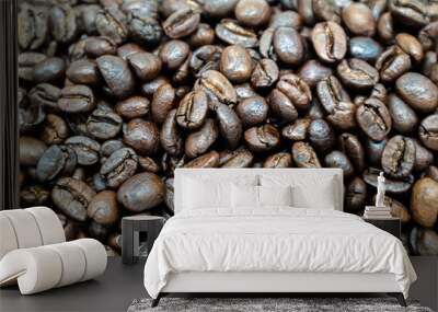 A group of fresh brown coffee beans was filmed in a natural close-up. Wall mural