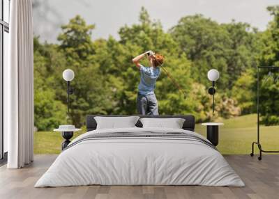 unknown student golfer practices his swing for the tournament Wall mural