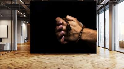 Woman's hands holding a wooden rosary and praying Wall mural