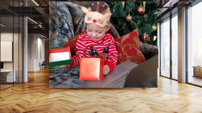 the kid is happy with the gift and congratulations through a laptop. Congratulations in quarantine Wall mural