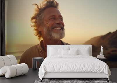 portrait of a happy senior mature man at beach during sunset enjoying his time  Wall mural