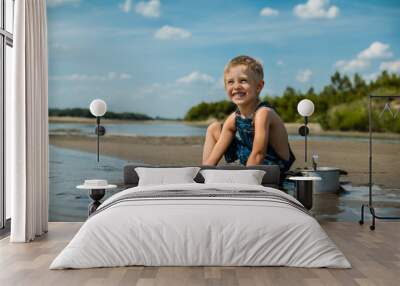 A little boy on the beach is playing in the search for gold.
Summer vacation concept Wall mural