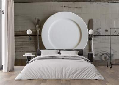 An empty plate with cutlery on both sides. Wall mural