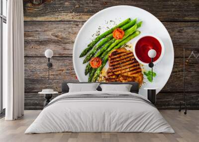 Barbecued meat and asparagus on wooden table Wall mural