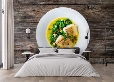 Fish dish - fried cod with spinach and capers in saffron sauce on wooden table
 Wall mural