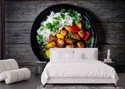 Fried chicken nuggets with white rice, bell peppers and parsley on wooden table Wall mural