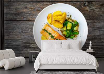 Fried salmon steak with lemon, fried potatoes and pak choi cabbage served on wooden table
 Wall mural