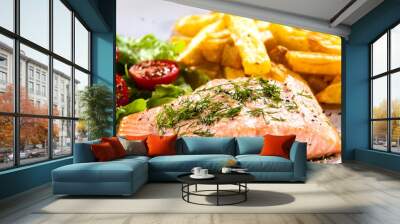 Fried salmon with french fries on wooden table Wall mural