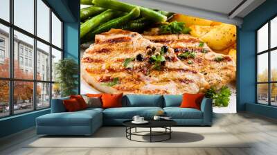 Grilled steaks, baked potatoes and vegetables Wall mural