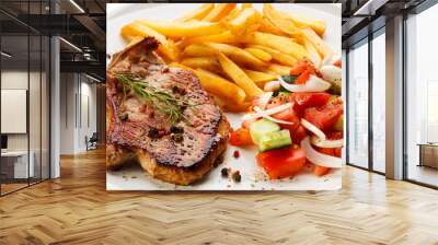 Grilled steaks, French fries and vegetables Wall mural