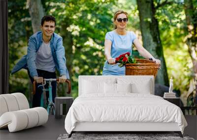 Healthy lifestyle - people riding bicycles in city park Wall mural