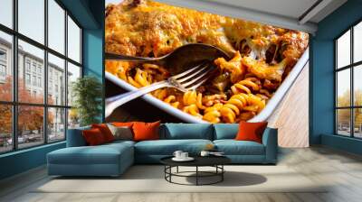 Noodle casserole with minced meat, mozzarella cheese and vegetables on wooden table
 Wall mural