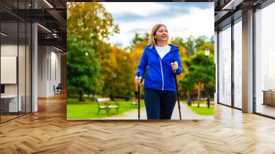 Nordic walking - woman training in city park
 Wall mural