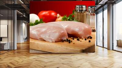 Raw chicken breasts on cutting board Wall mural