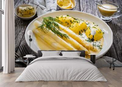 White boiled asparagus in hollandaise sauce with potato puree served on wooden black table
 Wall mural