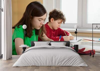 Young girl and boy learning Wall mural