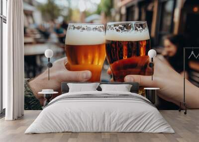 Close-up of two hands toasting with beer glasses. Wall mural