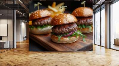 Three small burgers on a wooden board with chips. Wall mural