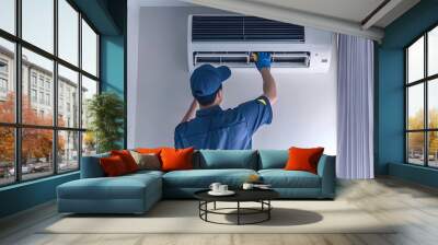 An air conditioning technician is repairing air conditioners in the room Wall mural