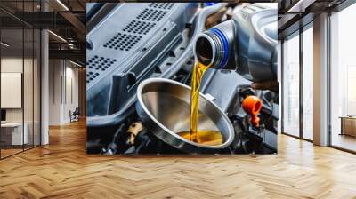 Close up car mechanic pouring engine oil into vehicle during car maintenance in auto garage Wall mural