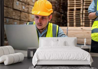 Wood worker man utilizes with laptop on job site, combining technology and expertise in wood warehouse  industry Wall mural