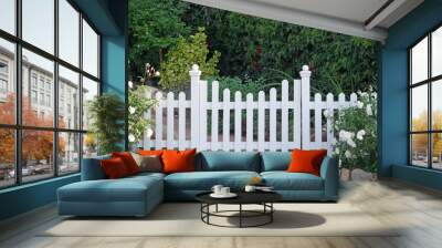 White picket fence with a gate and white roses on the left and right Wall mural