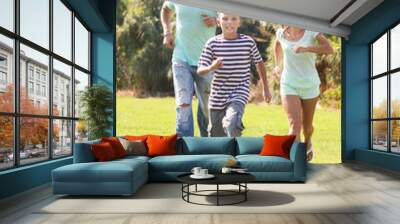  couple with teenager  playing with soccer ball Wall mural