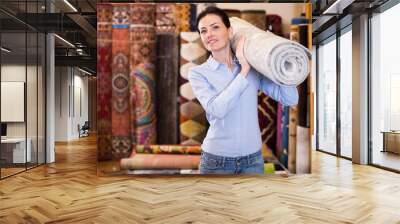 Adult woman buyer choosing colour carpets Wall mural