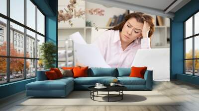 Bored and tired woman bookkeeper working in her workplace in office. Wall mural