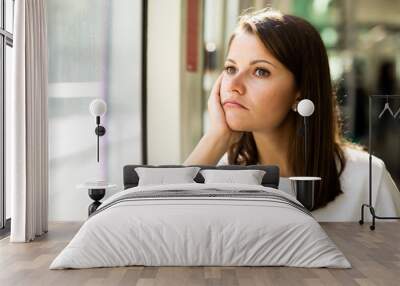 Bored unhappy woman sitting in tram Wall mural