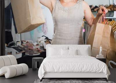 brunette female posing with bags in footwear shop Wall mural